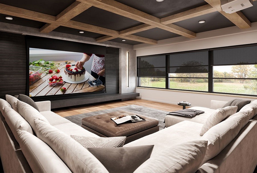 a home theater with white sofas and surround speakers 