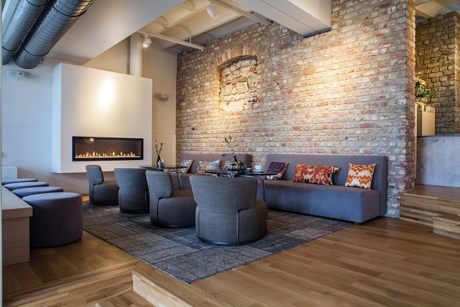 a living room with gray sofas and a fireplace