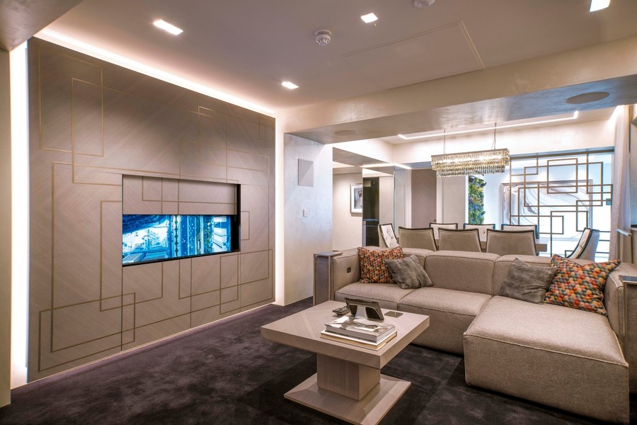 a living room with a TV hidden behind a wall cabinet