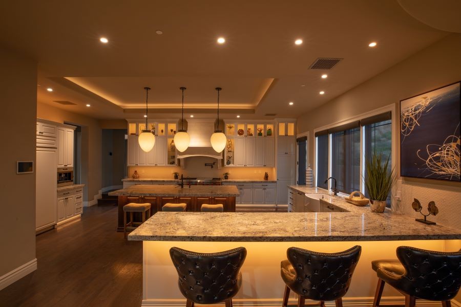 A softly lit kitchen with numerous fixtures using Vibrant LED linear lighting.