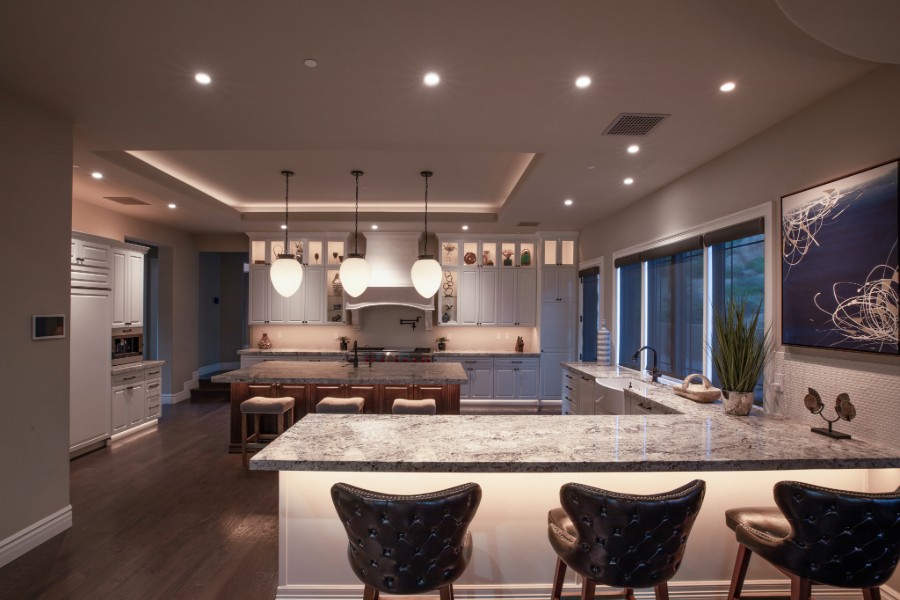 A modern kitchen featuring a spacious center island surrounded by stylish bar stools. 